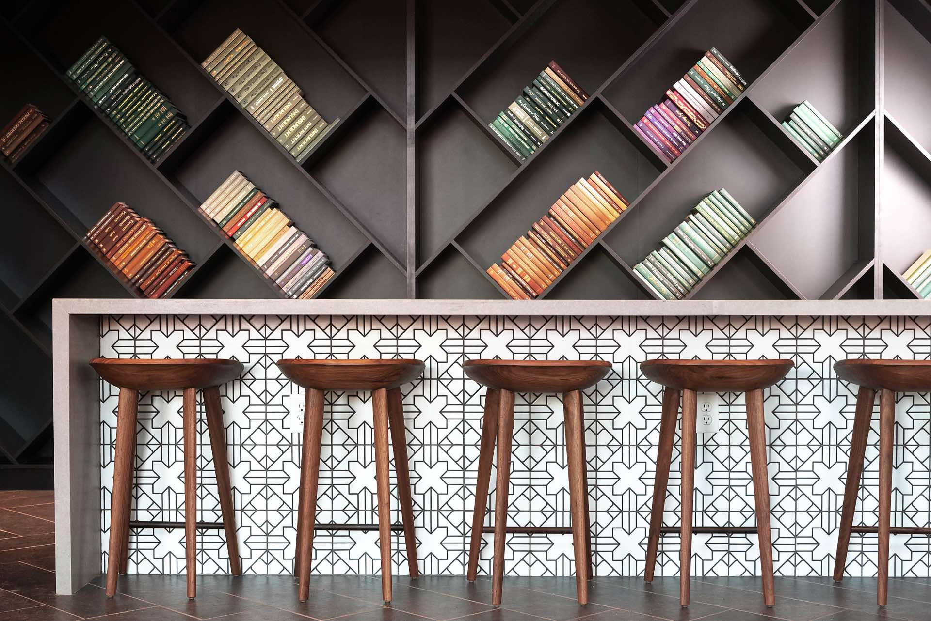Faraday Park East bar with modern design and wall of books